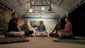 a group of people sitting in a room in meditation at Neerville Waterfall Glamping- Neer waterfall in Shivpuri