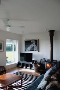 a living room with a couch and a fireplace at The Yanakie House & Cabins in Yanakie +3 photos