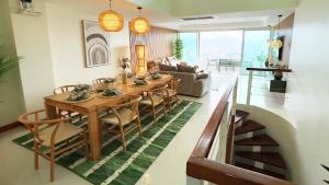 a living room with a wooden table and chairs at Mali Villa 57 in Patong Beach