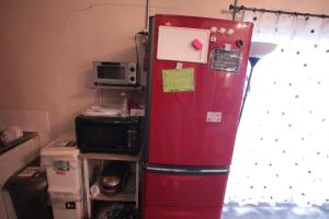 a red refrigerator in a kitchen next to a window at 2F - Vacation STAY 41669v in Okinawa City