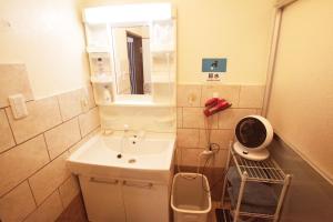 a small bathroom with a sink and a mirror at 2F - Vacation STAY 41669v in Okinawa City +24 photos