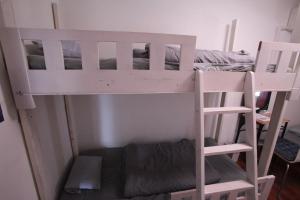 a bunk bed with a ladder next to a bed at 2F - Vacation STAY 41669v in Okinawa City