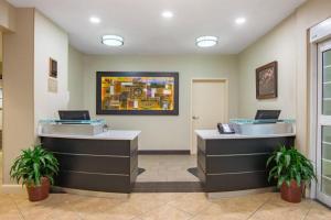 a lobby with two reception desks with laptops on them at Candlewood Suites Jefferson City By IHG in Apache Flats