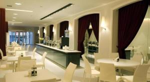 Jinjiang Inn Wuhan Hanjiang Road Metro Station Jiangtan Pedestrian Street في ووهان: مطعم بطاولات بيضاء وكراسي بيضاء