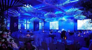a blue room with tables and chairs and chandeliers at Xian Grand Noble Hotel in Xi'an