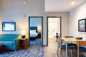 una camera d'albergo con letto, tavolo e divano di Home2 Suites By Hilton Kalamazoo Southeast a Kalamazoo