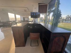 a bar with a chair in a room with tables at Takery Resort in Chittaurgarh