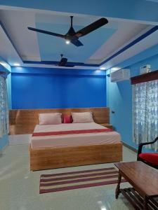 a bedroom with a bed with a ceiling fan at SEA SUN PARADISE in Port Blair