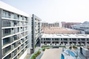 an aerial view of an apartment building at Bloomfields Executive 2BR Apt The Gate Masdar in Abu Dhabi