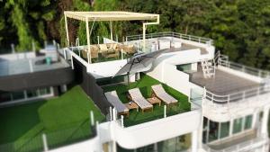 an aerial view of a house with chairs and tables at Mali Villa 57 in Patong Beach