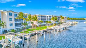 an image of a marina at a resort at Ocean View Penthouse Retreat amenities: tennis court heated Pool Vista Key Two in Islamorada
