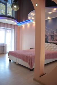 a bedroom with a bed and a blue light at 24home in Dnipro