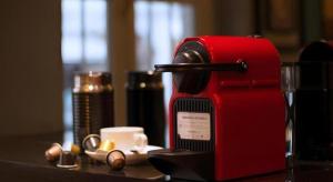a red coffee machine sitting on a table with a cup at The Keong Saik Hotel in Singapore