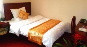 Ένα ή περισσότερα κρεβάτια σε δωμάτιο στο GreenTree Inn Shanghai South Railway Station Xujiahui Stadium Subway Station Shell Hotel