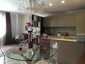 a kitchen with a glass table and a dining room at L'Angolino Nascosto in Verona