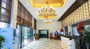 a lobby of a building with a chandelier at GreenTree Inn Jiangsu Suzhou New District Science and Technology College Business Hotel in Suzhou