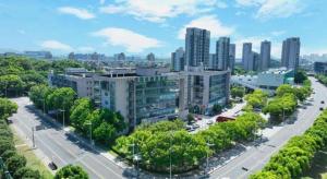 an aerial view of a city with buildings and trees at GreenTree Inn Jiangsu Suzhou New District Science and Technology College Business Hotel in Suzhou