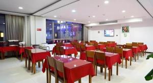 a dining room with red tables and chairs at GreenTree Inn Shanghai Jiading Newtown MaLu Subway Station Business Hotel in Jiading