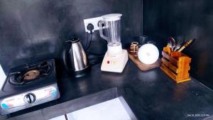 a kitchen counter with a blender on top of it at DKC Apartment in Ahangama