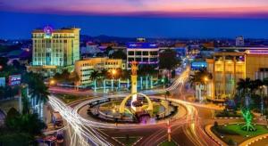 a city lit up at night with buildings and street lights at LUCKY STAR HOTEL in Buon Ma Thuot