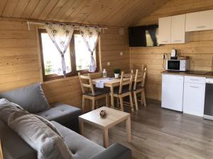 a living room with a couch and a table at Osada w Karkonoszach in Kowary