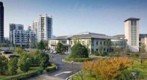 a large building in a city with tall buildings at Huizhou Wanyun Holiday Hotel in Huangshan