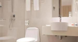 a white bathroom with a toilet and a sink at City Comfort Inn Hengyang Dayang Department Lianhu Plaza in Hengyang +39 photos
