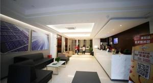 a lobby of a building with people walking in it at City Comfort Inn Hengyang Dayang Department Lianhu Plaza in Hengyang