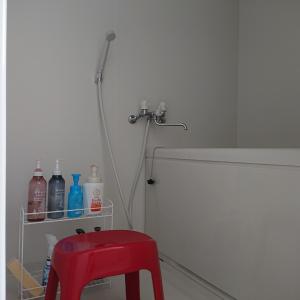 a red stool in a bathroom with a shower at Lapus Honmachi No.200 / Vacation STAY 57908 in Hikone +19 photos
