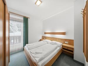 En eller flere senge i et værelse på Mittersill apartment close to ski lifts