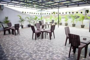 a group of tables and chairs in a patio at Grey House Tebet in Jakarta