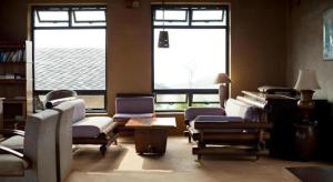 a living room with a lot of chairs and windows at Hananoie - A Permaculture Resort in Astam +143 photos