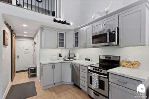 a kitchen with white cabinets and a stove top oven at #LazyBear Tahoe Dreamy Escape in Tahoe Vista