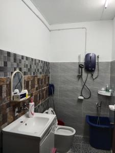 a bathroom with a toilet and a sink at Village House With River View And Karaoke 8 to10 Pax in Jeram