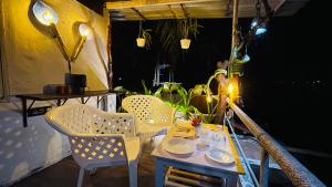 a table and two chairs on a balcony with a table and chairs at Palm Breeze in Udupi