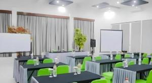 a conference room with tables and green chairs at Fizz Hotel Lombok in Tanjungkarang +179 photos