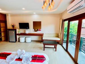 een kamer met een slaapkamer met een bed en een tafel bij Baan Saranrom in Amphawa