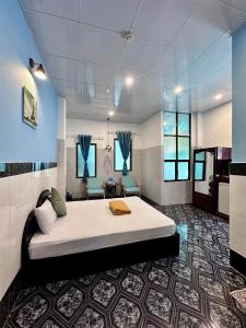 a bedroom with a large bed in a room at Nam Đô Hotel Cần Thơ Downtown in Can Tho