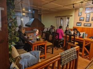 a group of people sitting at tables in a restaurant at Balthali Village Resort-Balthali in Panauti +46 photos