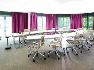 a conference room with white tables and chairs and purple curtains at Novotel Paris Orly Rungis Aéroport in Rungis
