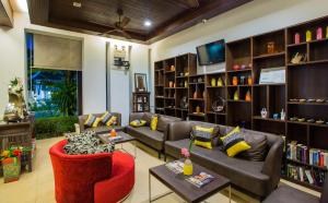 a living room with a couch and chairs and a tv at Apasari Krabi - SHA Extra Plus in Ao Nang Beach