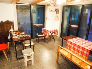 a dining room with tables and chairs and a table with food at Mua Guesthouse in Namwon