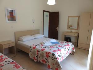 a hotel room with two beds and a mirror at Kymata by Anastasia in Stavros