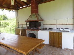 a kitchen with a wooden table and an oven at Kymata by Anastasia in Stavros