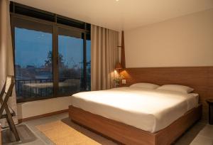 Ένα ή περισσότερα κρεβάτια σε δωμάτιο στο Than Coffee & Homestay