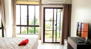 a bedroom with a bed with a red pillow on it at THE ALL 24 Luxury Residence in Bangkok +48 photos