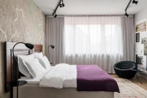 a bedroom with a bed and a window at STORY HOTEL STOCKHOLM STUREPLAN, in JdV by Hyatt in Stockholm