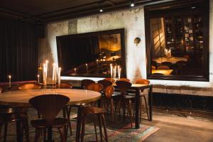 a restaurant with tables and chairs and a mirror at STORY HOTEL STOCKHOLM STUREPLAN, in JdV by Hyatt in Stockholm
