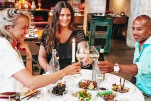 a group of people sitting around a table with wine glasses at STORY HOTEL STOCKHOLM STUREPLAN, in JdV by Hyatt in Stockholm