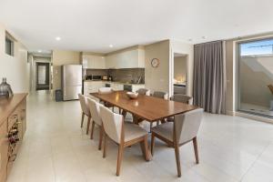 a kitchen and dining room with a wooden table and chairs at Salt 13 Luxury Apartment in Sorrento